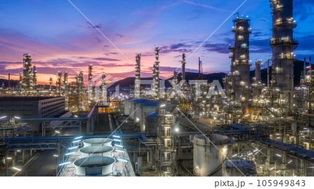 Aerial view oil and gas tank with oil refinery background at night, Glitter lighting of petrochemical plant with night, Manufacturing of petroleum, Products tank in petrochemical plant. 105949843