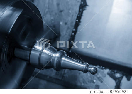 The  CNC lathe machine forming  cutting the metal shaft parts. 105950923