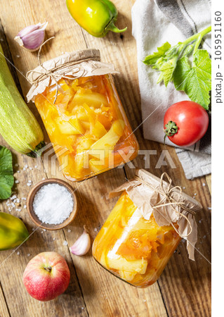 Healthy homemade fermented food. Salad with courgette (zucchini) and vegetables on a rustic table. Home economics, autumn harvest preservation. View from above. 105951160
