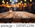 Wooden table with candle lantern on blurred evening lights abstract background 105951296