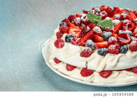 Pavlova dessert with layers of meringue and whipped cream with berries, Long banner format. top view Pavlova dessert with layers of meringue and whipped cream with berries, Long banner format. top view 105954389