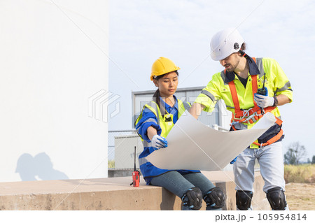 Wind turbine technician checking and maintenance at turbine station. Wind turbine technician checking and maintenance at turbine station. 105954814