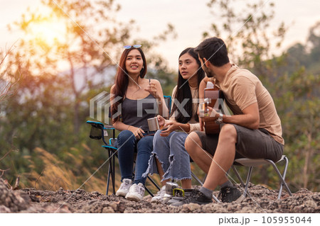 man and two women three people happy together, picnic in forest, 105955044