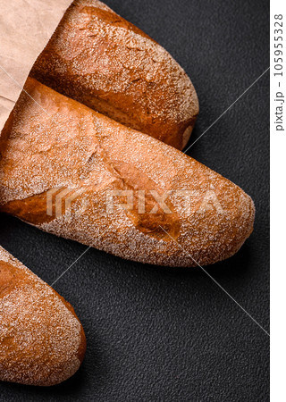 French baguette bread on a dark textured concrete background 105955328