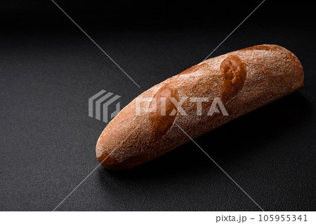 French baguette bread on a dark textured concrete background 105955341