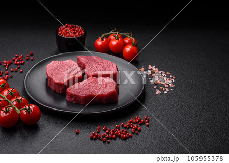 Juicy fresh raw beef meat with salt, spices and herbs Juicy fresh raw beef meat with salt, spices and herbs 105955378
