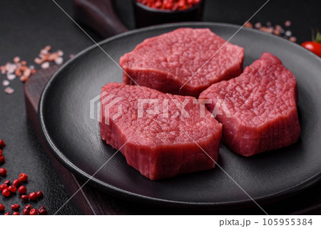 Juicy fresh raw beef meat with salt, spices and herbs Juicy fresh raw beef meat with salt, spices and herbs 105955384