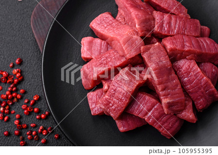 Juicy fresh raw beef meat with salt, spices and herbs 105955395