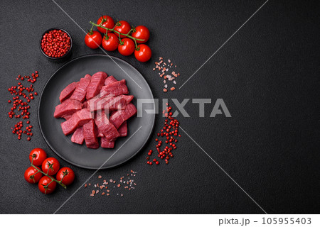 Juicy fresh raw beef meat with salt, spices and herbs 105955403