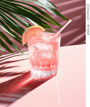Pink cocktail with lemon wedge sitting on the pool table 105956222