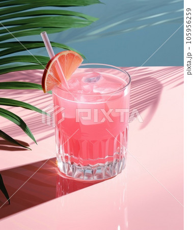 Pink cocktail with lemon wedge sitting on the pool table 105956259