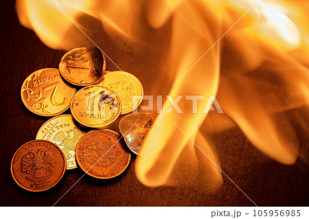 Russian coins, deformed and broken money on fire. The idea of the collapse of the ruble and the economy, sanctions against Russian aggression, layout on a black stone background Russian coins, deformed and broken money on fire. The idea of the collapse of the ruble and the economy, sanctions against Russian aggression, layout on a black stone background 105956985