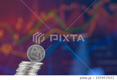 The Russian ruble falls out of the column of coins against the background of the exchange rate chart. Economic sanctions and economic crisis, space for text, idea for banner and news 105957831