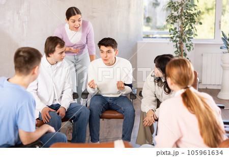 Group of students preparing for exam together in classroom of college 105961634