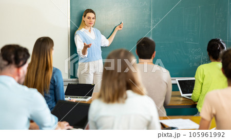 Female teacher giving lecture in classroom 105961992