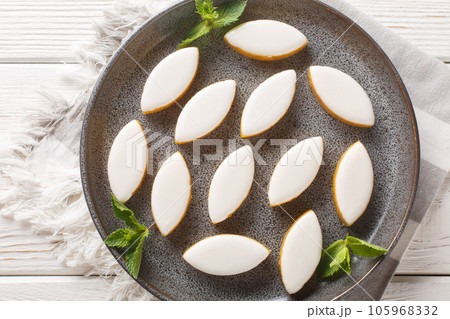 Calissons French glazed almonds bonbons with white icing closeup. Horizontal top view Calissons French glazed almonds bonbons with white icing closeup. Horizontal top view 105968332