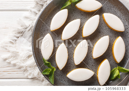 Calissons are a Provencal candy composed of a light paste of crystallised melon, orange and almonds coated with royal icings closeup. Horizontal top view 105968333