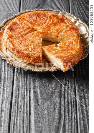 Kouign amann is a round multi-layered cake containing with laminated dough soaked in butter and sugar closeup on the plate. Vertical Kouign amann is a round multi-layered cake containing with laminated dough soaked in butter and sugar closeup on the plate. Vertical 105968355