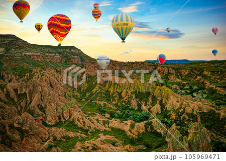 Cappadocia, Turkiye - July 07, 2023-Air balloons in Cappadocia-unreal views in valley. Cappadocia, Turkiye - July 07, 2023-Air balloons in Cappadocia-unreal views in valley. 105969471