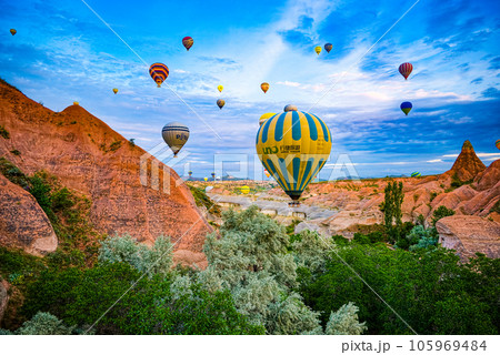 Cappadocia, Turkiye - July 07, 2023-Air balloons in Cappadocia-unreal views in valley. 105969484
