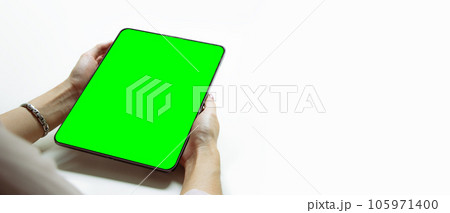 Mockup image, woman holding black digital tablet with blank green screen on white background. 105971400
