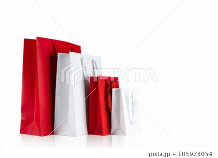 Various sizes of holiday shopping gift bags on isolated white background.  105973054