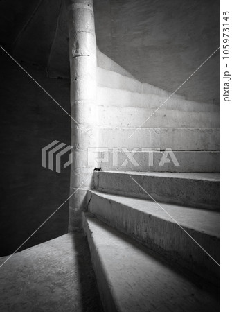 Close up shot of a stone spiral staircase in a French building 105973143