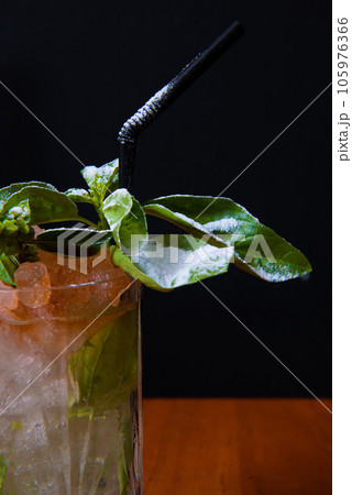delicious cocktail or refreshing mix served and decorated by a bartender delicious cocktail or refreshing mix served and decorated by a bartender 105976366