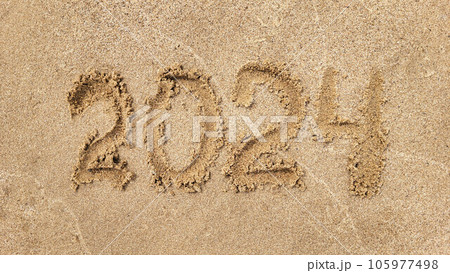 The numbers 2024 are written on the sandy beach. The concept of the new year The numbers 2024 are written on the sandy beach. The concept of the new year 105977498