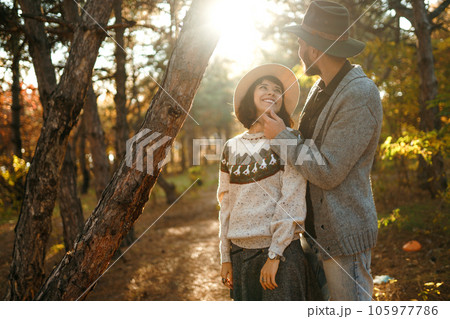 Lovely hipster couple looking at each other. Couple wearing beautiful hats and sweaters. Lovely hipster couple looking at each other. Couple wearing beautiful hats and sweaters. 105977786