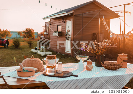 A covered wooden table in the courtyard of a country house. Country life, life in the country. A covered wooden table in the courtyard of a country house. Country life, life in the country. 105981009