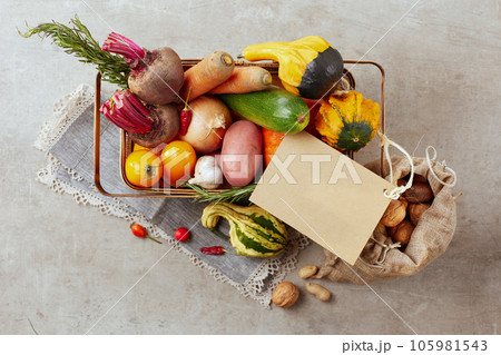 autumn flat lay on grey background with tag and pumpkins 105981543