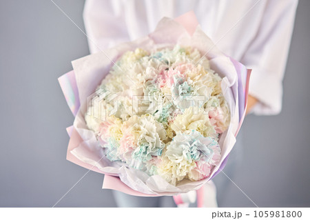 Beautiful mono bouquet of flowers in woman hand. Floral shop concept . Beautiful fresh cut bouquet. Flowers delivery Beautiful mono bouquet of flowers in woman hand. Floral shop concept . Beautiful fresh cut bouquet. Flowers delivery 105981800