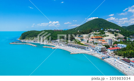 Amazing aerial view of Black Sea coast, turquoise color of the sea. Summer landscape with mountains, green forest, azure water, and blue sky in bright sunny day. Travel background. Top view. Amazing aerial view of Black Sea coast, turquoise color of the sea. Summer landscape with mountains, green forest, azure water, and blue sky in bright sunny day. Travel background. Top view. 105983034