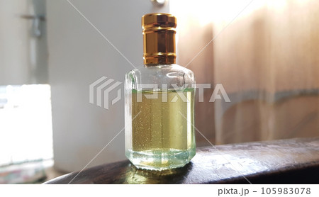 close up view of an oud attar oil glass bottle isolated on blurred background close up view of an oud attar oil glass bottle isolated on blurred background 105983078