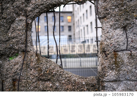 Hole in Broken Berlin wall and walking person against Hole in Broken Berlin wall and walking person against 105983170