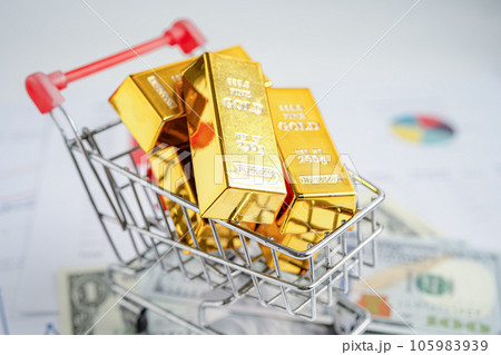 Gold bar in shopping cart on US dollar banknotes money and graph, economy finance exchange trade investment concept. 105983939
