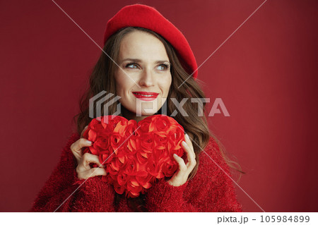 smiling elegant woman in red sweater and beret with red heart smiling elegant woman in red sweater and beret with red heart 105984899
