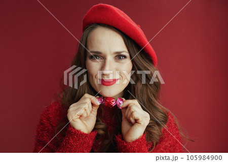 happy elegant 40 years old woman in red sweater and beret happy elegant 40 years old woman in red sweater and beret 105984900