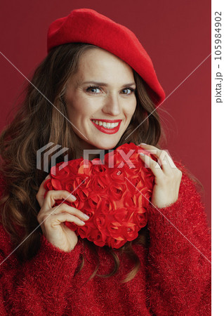 smiling elegant woman in red sweater and beret 105984902