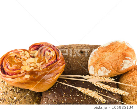 Bread, baguettes and sweet pastries on a white. Free space for text. 105985134