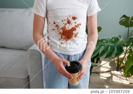 The child spilled coffee on his clothes. The concept of a stain on a t-shirt. 105987209