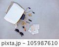 White handbag open with pills and women's accessories. 105987610