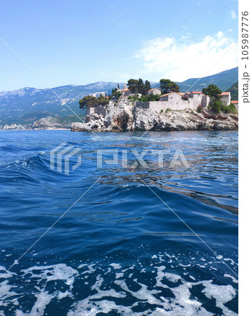 Sveti Stefan, small islet and resort in Montenegro - view from the water. Budva riviera. Balkans, Adriatic sea, Europe. Beauty world. 105987776