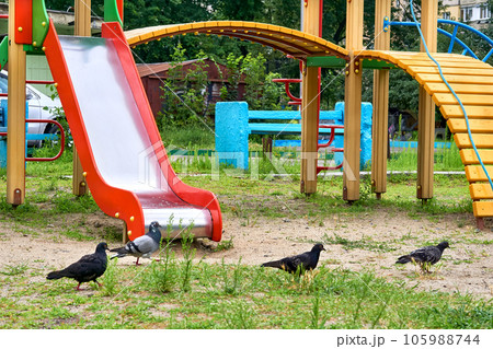 Summer spring children's playground with painted toy slide in park 105988744