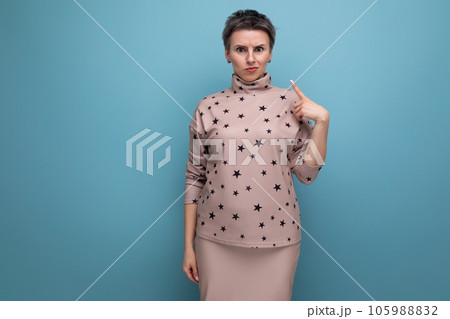 serious young caucasian dark-haired lady in a skirt and blouse with a short haircut 105988832