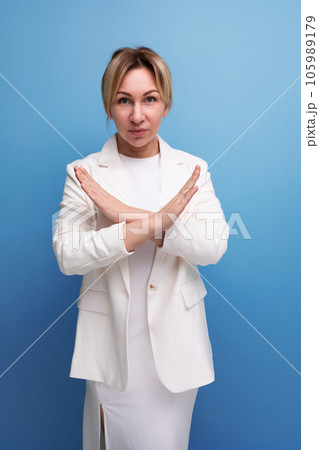 young well-groomed blond boss woman in a white jacket crossed her arms young well-groomed blond boss woman in a white jacket crossed her arms 105989179