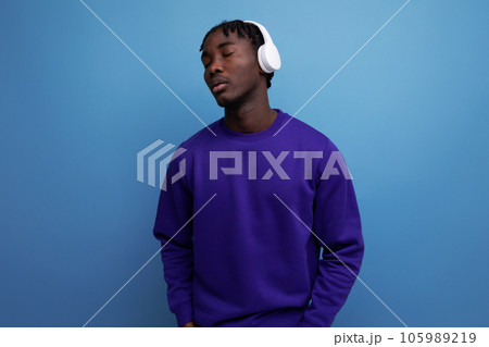african young brunette male with dreadlocks with wireless headphones african young brunette male with dreadlocks with wireless headphones 105989219