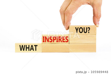 What inspires you symbol. Concept words What inspires you on wooden block. Beautiful white table white background. Businessman hand. Business motivational what inspires you concept. Copy space. 105989448