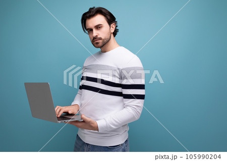 smart european young guy with chic black hair with laptop smart european young guy with chic black hair with laptop 105990204